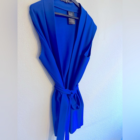 Royal blue pants and cardigan with belt.